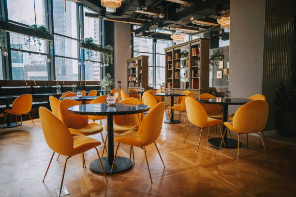 modern Cafe restaurant interior with yellow chair against window with city view
